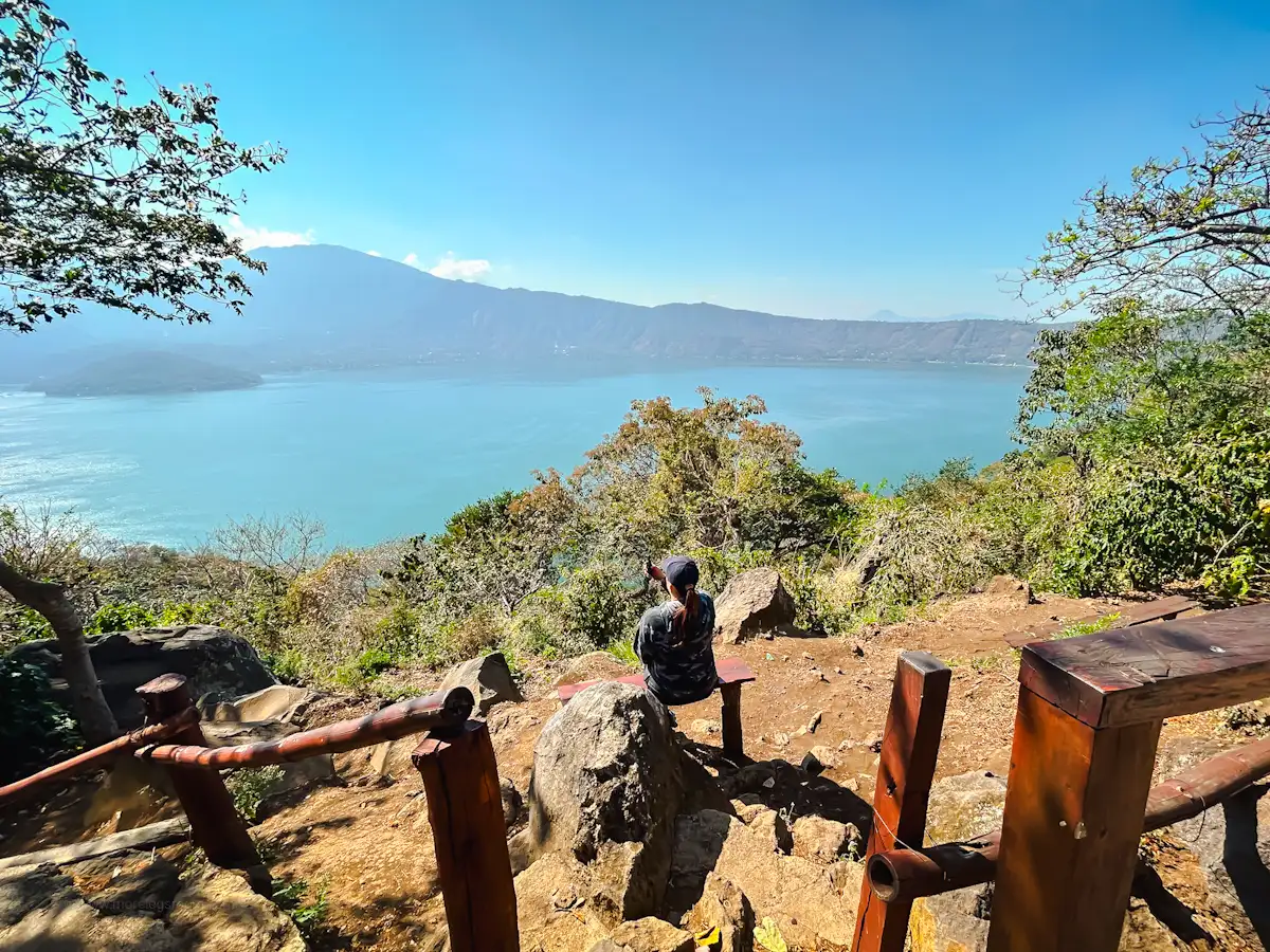 Sunset over Lago de Coatepeque with lakefront restaurants and calm waters