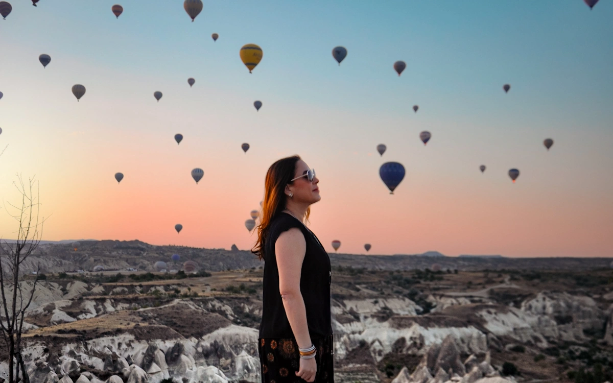 this is karen lee from more legs room chasing bucket list adventures and watching  hot air balloons in the goreme valley in capadoccia turkiye during sunrise this is karen lee from more legs room chasing bucket list adventures and watching  hot air balloons in the goreme valley in Cappadocia turkiye during sunrise