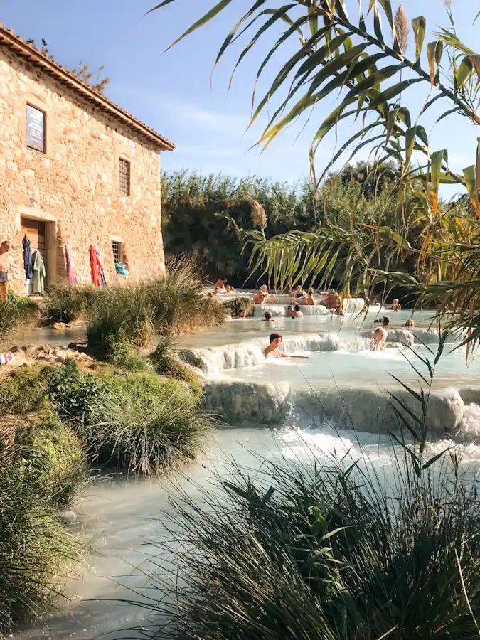 People bathing in the hot spring waters of cascate del mulino